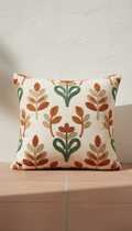 Embroidered cotton throw pillow, Single product showcased at a time on a matte plaster pedestal or terracotta tile surface...