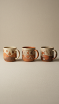 Earthy Clay ceramic mug, Use a 3/4 angle to capture the full design of each mug, highlighting their unique illustrations....