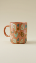 Custom ceramic mug, Three-quarter angle hero shots on gently textured neutral backgrounds (matte Soft Cream), with light...